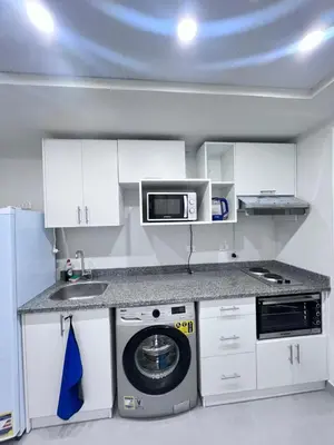 a kitchen with a washing machine and a microwave at Scandic Hotel Hurghada in Hurghada