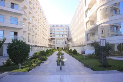an empty courtyard in a large building with trees at Scandic Hotel Hurghada in Hurghada