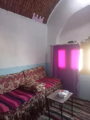 a living room with a couch and a table at Nubian dream house in Jazīrat Fīlah