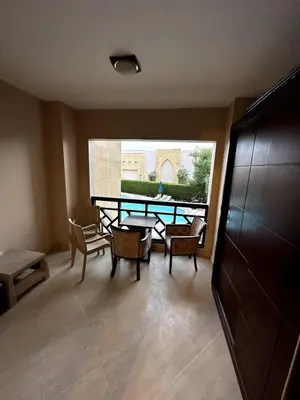 a room with a table and chairs and a window at studio in a 5 star hotel in Hurghada