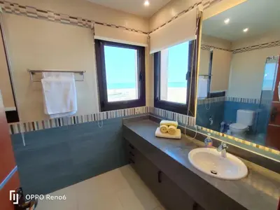 a bathroom with a sink and a mirror at Luxury 2 bedroom in fandir el gouna in Hurghada
