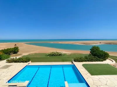 an aerial view of a swimming pool and the ocean at Luxury 2 bedroom in fandir el gouna in Hurghada