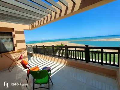 a balcony with a view of the beach at Luxury 2 bedroom in fandir el gouna in Hurghada