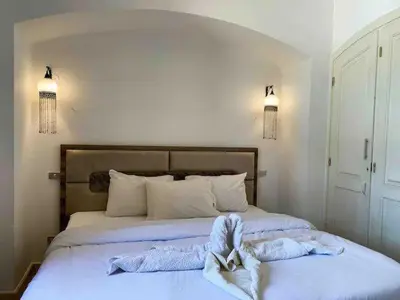 a bedroom with a bed with towels on it at Luxury villa west golf in Hurghada