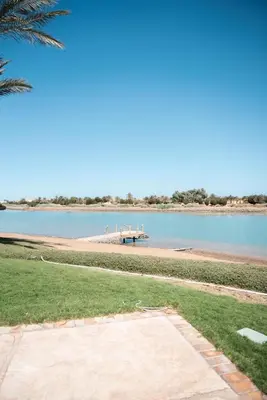 a beach with a pier in the middle of the water at Luxury villa west golf in Hurghada