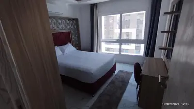 a bedroom with a white bed and a window at Fanadir Bay Resort in Hurghada