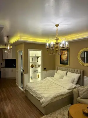 a bedroom with a large bed and a chandelier at The best Studio in Hurghada