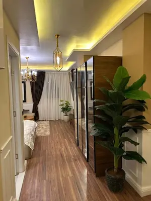 a room with a potted plant and a bedroom at The best Studio in Hurghada