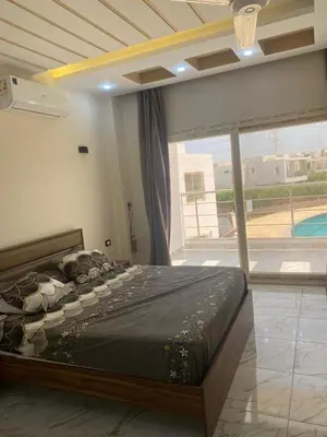a large bed in a room with a large window at Sky star 135 in Hurghada