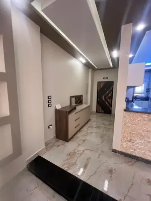 an empty room with a desk and a painting on the wall at Sky star 135 in Hurghada