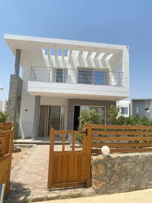 a house with a wooden fence in front of it at Sky star 135 in Hurghada