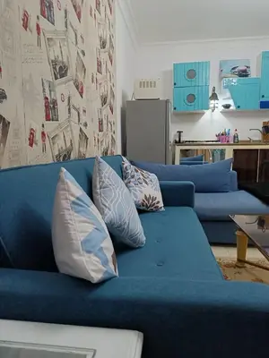 a blue couch with pillows in a living room at The View in Hurghada