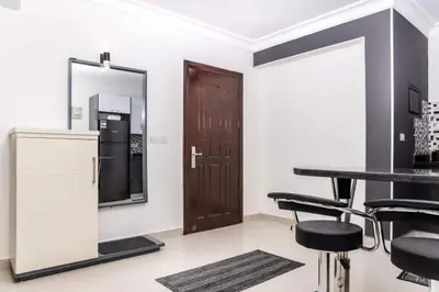 a room with a table and chairs and a mirror at Cozy and spacious apartment for family , view sea in Hurghada
