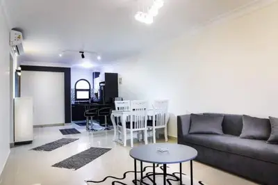 a living room with a couch and a table at Cozy and spacious apartment for family , view sea in Hurghada