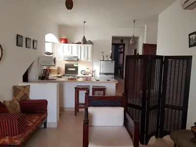 a living room with a couch and a kitchen at Sabina Y97- 23 in Hurghada