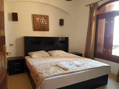 a bedroom with a bed with two towels on it at Sabina Y97- 23 in Hurghada