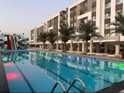 a large swimming pool in front of a building at Fanadir Bay Resort in Hurghada