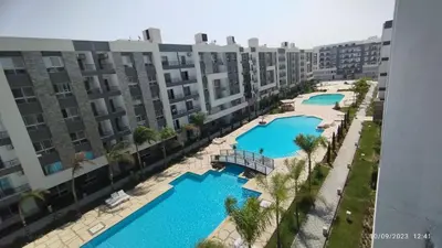 an aerial view of two pools in a apartment complex at Fanadir Bay Resort in Hurghada