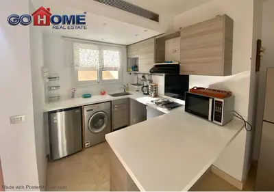 a kitchen with a white counter top and a microwave at Stylish 1 Bedroom at Scarab - El-Gouna WS14 in Hurghada