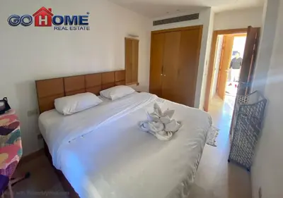 a bedroom with a bed with a blue flower on it at Stylish 1 Bedroom at Scarab - El-Gouna WS14 in Hurghada