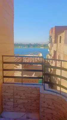 a balcony with a view of a body of water at Memo home in Jazīrat al ‘Awwāmīyah