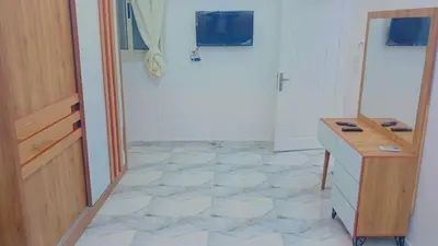 a kitchen with a counter and a tile floor at Memo home in Jazīrat al ‘Awwāmīyah