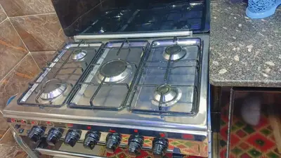 a stove top oven sitting in a kitchen at Memo home in Jazīrat al ‘Awwāmīyah