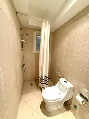 a bathroom with a toilet and a shower at Stunning 2BR Apartment - Al Dora Resort, Hurghada in Hurghada