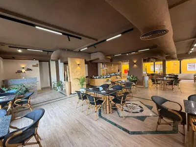 a restaurant with tables and chairs in a room at Stunning 2BR Apartment - Al Dora Resort, Hurghada in Hurghada