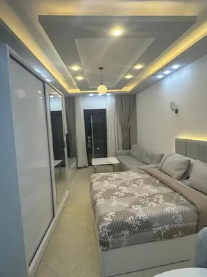 a bedroom with a bed and a living room at Al Saraya Sahl Hashish Serenity Chalet in Hurghada