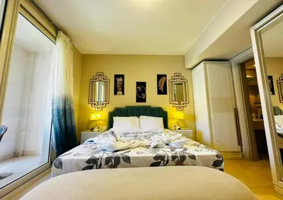 a bedroom with two beds and a large window at One bedroom in gouna in Hurghada