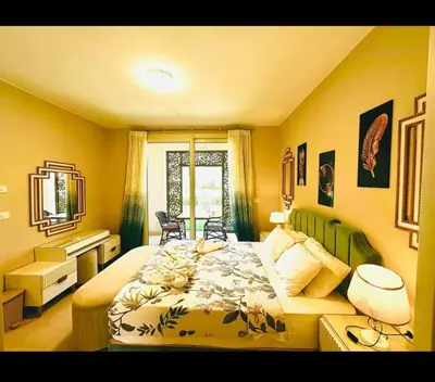 a bedroom with a large bed and a desk at One bedroom in gouna in Hurghada
