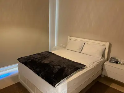 a bed with a black blanket on it in a room at Sea View Haven at Mangroovy in Hurghada
