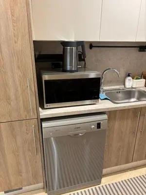 a kitchen with a microwave and a sink at Sea View Haven at Mangroovy in Hurghada
