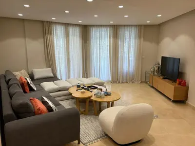a living room with a couch and a tv at Sea View Haven at Mangroovy in Hurghada