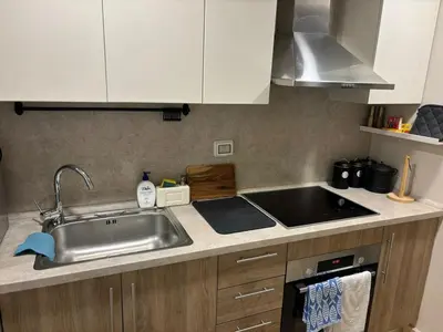 a kitchen counter with a sink and a stove at Sea View Haven at Mangroovy in Hurghada