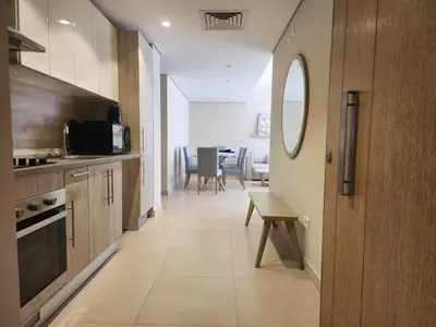 a kitchen and dining room with a table and chairs at Elgouna - Mangroovy 2BR - Pool & Sea view in Hurghada