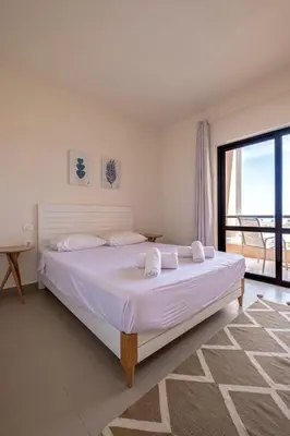 a bedroom with a large bed with a large window at Fanadir 3BR • Prime Sea View Villa in Hurghada