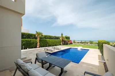 a villa with a swimming pool and a patio at Fanadir 3BR • Prime Sea View Villa in Hurghada