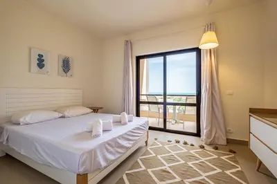 a bedroom with a bed and a large window at Fanadir 3BR • Prime Sea View Villa in Hurghada