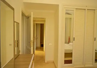 a room with a bedroom with a bed and a mirror at Stylish 4 BR with a Private Heated Pool V15 at White Villas in Hurghada