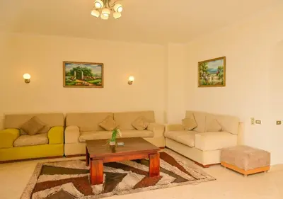 a living room with two couches and a coffee table at Stylish 4 BR with a Private Heated Pool V15 at White Villas in Hurghada