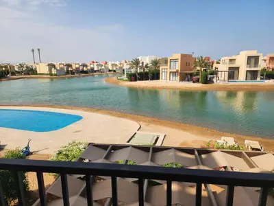 a view of a body of water from a balcony at Gouna - Tawila 1BR breathtaking lagoon & pool view in Hurghada