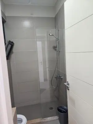 a bathroom with a shower with a glass door at Gouna - Tawila 1BR breathtaking lagoon & pool view in Hurghada