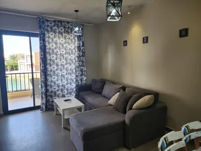 a living room with a couch and a table at Gouna - Tawila 1BR breathtaking lagoon & pool view in Hurghada