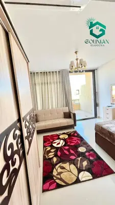 a living room with a bed and a couch at Cozy studio G-cribs in Hurghada