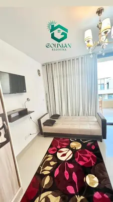 a room with a bed and a rug on the floor at Cozy studio G-cribs in Hurghada