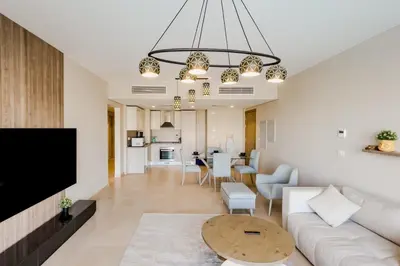 a living room with a couch and a table at Radiant & Refined 2BDR MangroovyFree Beach & Pool in Hurghada