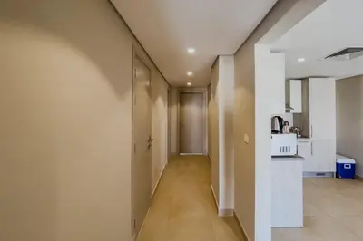 a hallway leading to a kitchen in a house at Radiant & Refined 2BDR MangroovyFree Beach & Pool in Hurghada