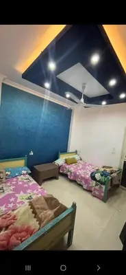 a bedroom with two beds and a blue wall at GZ Resort in Hurghada